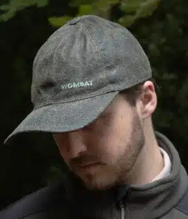 man wearing a green leather cap by wombat