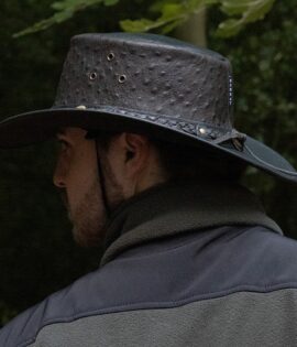 man wearing a black leather hat side on view