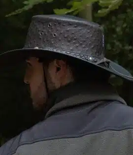 man wearing a black leather hat side on view