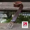 brown handmade in britain leather belt on a wooden step