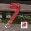 red handmade in britain leather belt on a wooden step