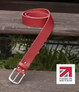 red handmade in britain leather belt on a wooden step