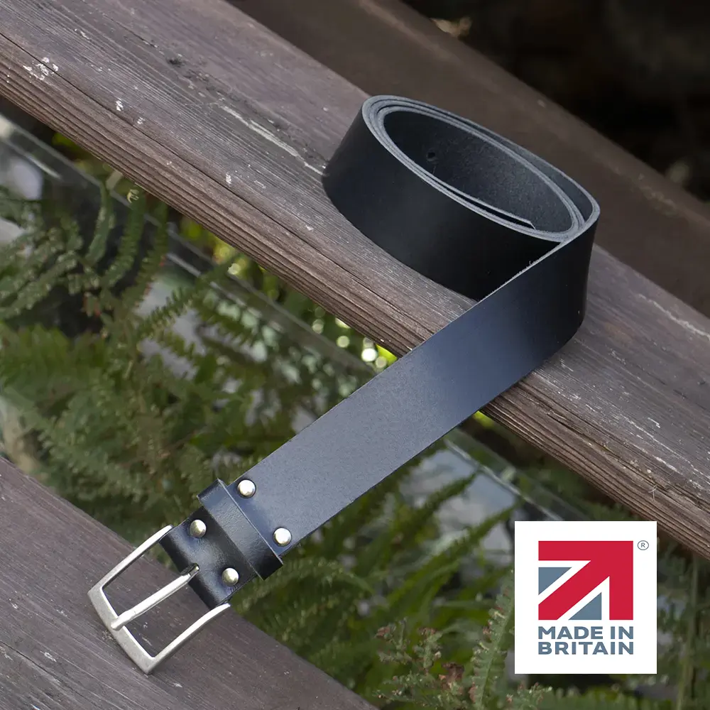 black handmade in britain leather belt on a wooden step