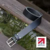 black handmade in britain leather belt on a wooden step