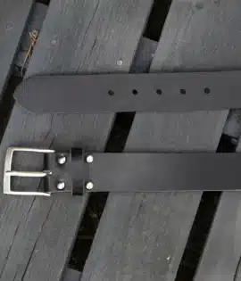 premium black english hide leather belt on a wooden step