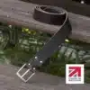 dark brown handmade in britain leather belt on a wooden step
