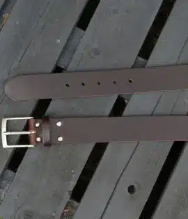premium dark brown english hide leather belt on a wooden step