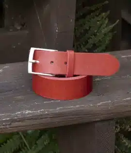 premium red english hide leather belt on a wooden step
