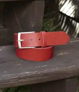 premium red english hide leather belt on a wooden step