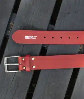 premium red english hide leather belt on a wooden step showing made in britain stamp