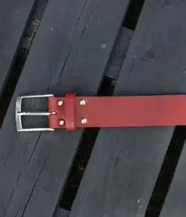 premium red english hide leather belt on a wooden step