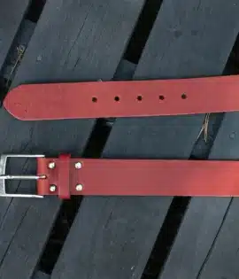premium red english hide leather belt on a wooden step