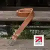 tan colour handmade in britain leather belt on a wooden step