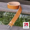 tan colour handmade in britain leather belt on a wooden step