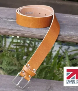 tan colour handmade in britain leather belt on a wooden step