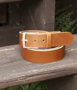 premium tan english hide leather belt on a wooden step