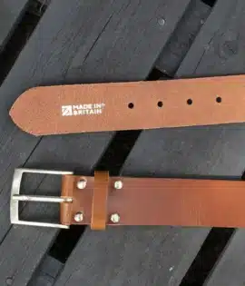 premium tan english hide leather belt on a wooden step showing made in britain stamp