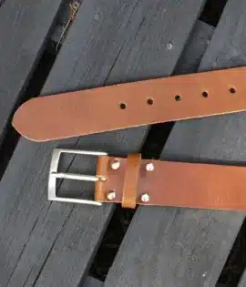 premium tanenglish hide leather belt on a wooden step